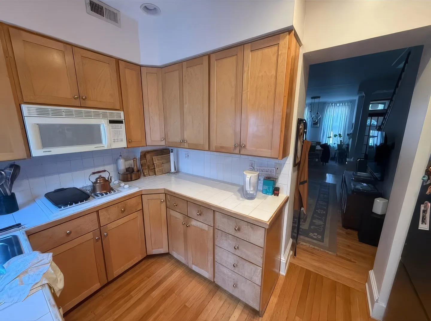 Kitchen before and after cabinet refinishing — before