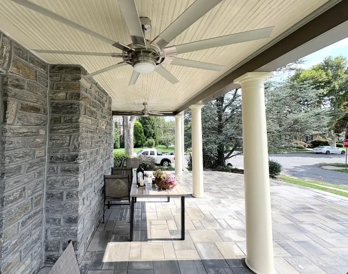 Covered porch with beadboard ceiling and columns painted warm white